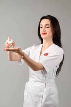 The girl holds a cream for skin care in her hands, a portrait of a cosmetologist with a cream in her hands.
