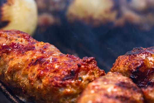 Traditional Romanian food Meat Balls "mici" on grill. Tasty meat balls on barbeque, pork meat on charcoal barbecue