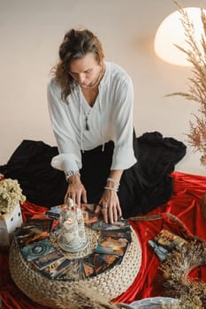 Women's circle and practice in the use of metaphorical cards. The girl is sitting surrounded by flowers.