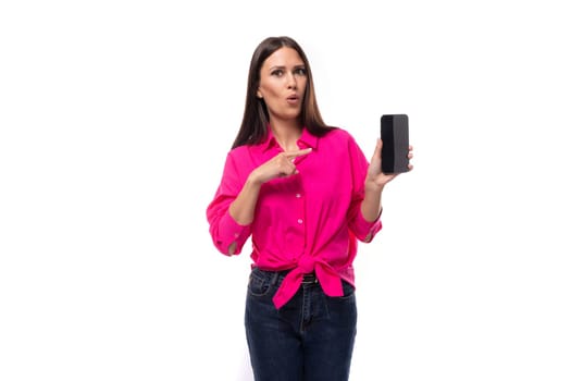 young cute caucasian brunette woman in pink shirt showing smartphone screen.