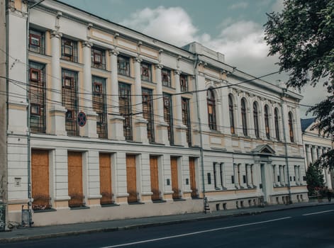 Old damaged architecture in Kharkiv in spring. Cityscape photo in Ukraine. Urban city life during the war. High quality picture for wallpaper, travel blog.