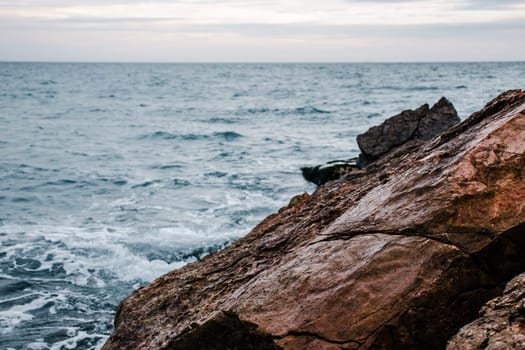 Winter sea with stones on the beach concept photo. Underwater rock. Mediterranean sea. The view from the top, nautical background. High quality picture for wallpaper