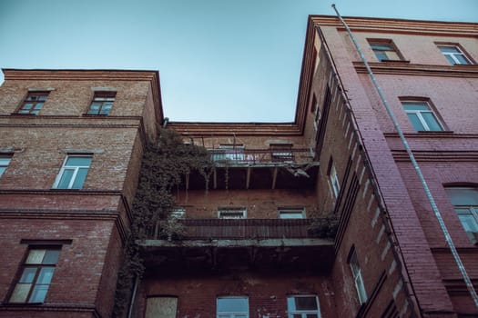 Old city architecture backyard with large balcony, Kharkiv. Cityscape photo in Ukraine. Urban city life during the war. High quality picture for wallpaper, travel blog.