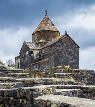 Old stone church in rural field scene concept photo. Monastery complex located on the hill. High quality picture for wallpaper