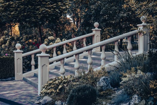 Staircase in the park, marble railings side view concept photo. Beautiful nature scenery photography. Idyllic scene. High quality picture for wallpaper, travel blog, magazine, article