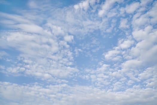 White fluffy clouds on background blue sky.