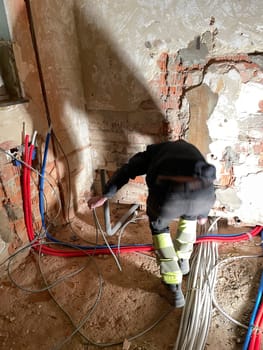 Electrician working working on building site, Maintenance technicians install wiring in the home. High quality photo