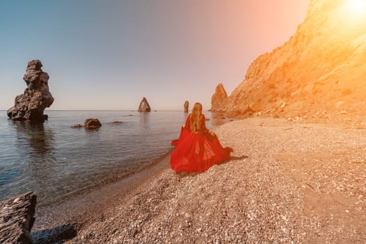 woman sea red dress Happy woman in a flying red dress and with long hair, runs on the seashore.