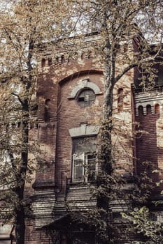 Old vintage brick building in autumn cityscape concept photo. Urban city life. District of European town. High quality picture for wallpaper