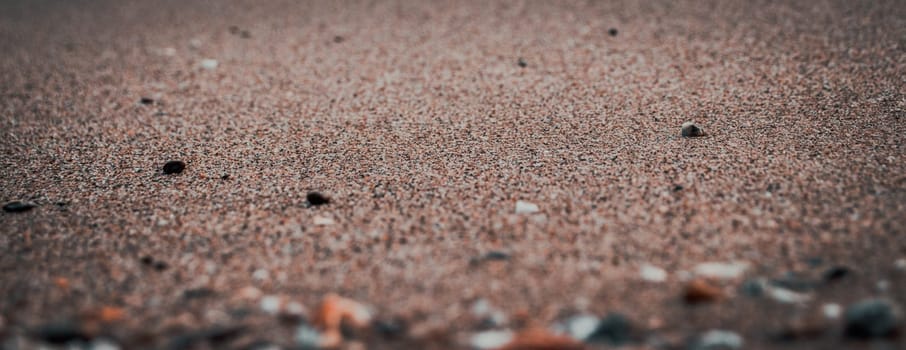 Close up sand beach background concept photo. Colorful small sea stones on the beach. Front view photography with blurred background. High quality picture for wallpaper, travel blog, magazine, article