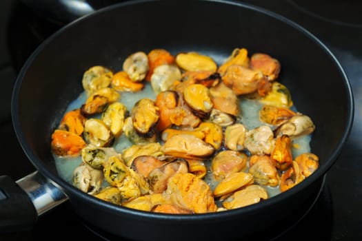 Delicious Pan of Freshly Cooked Mussels on a Stove. Selective focus