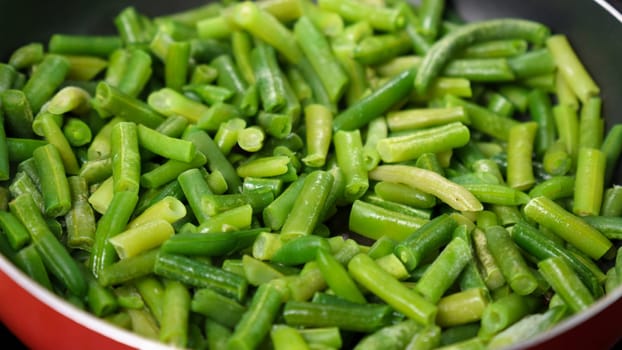 Green Beans Sizzling in Pan, Creating a Mouthwatering Dish. Selective focus