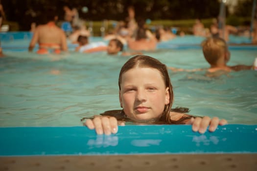 A little girl at the edge of the pool. Little girl in the pool. Young woman on the edge of the pool. Eighties vibes. The concept of summer, summer pleasures, water fun and relaxation.