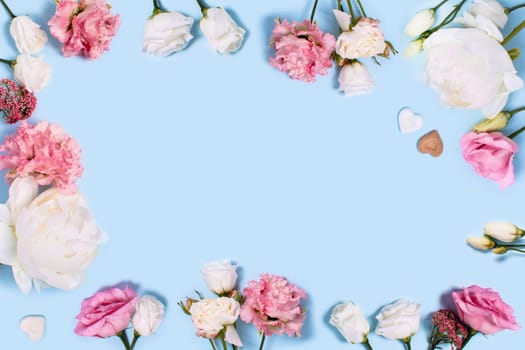 Blue background with peonies and roses. Top view with space for your text.