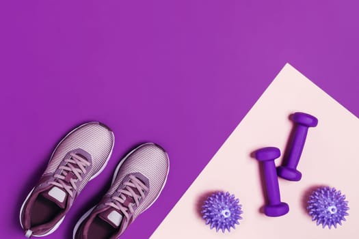 Sports equipment and shoes for women's training. Pink-purple background, diagonal composition.