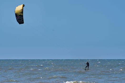 Kitesurfer in the still sea waters of beach Scheveningen in the Netherlands