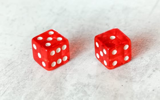 Two translucent red craps dices on white board showing Easy Six / Jimmie Hicks (number 5 and 1)