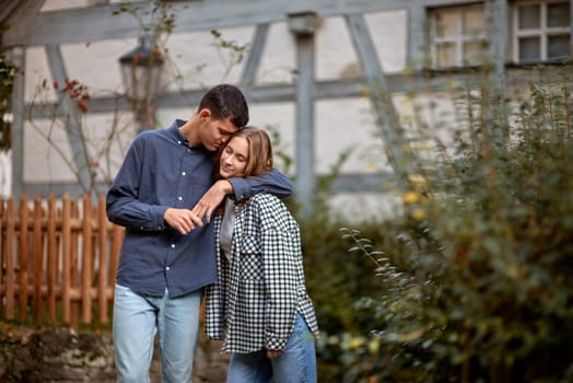 Young Cute Female Hugs Boyfriend. In Autumn Outdoor. Lovers Walking in Park. Attractive Funny Couple. Lovestory in Forest. Man and Woman. Cute Lovers in the Park. Family Concept. Happy Couple.