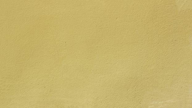 Old wall painted with yellow, paint. Texture of time-damaged paint. ..Texture for design with copy space.