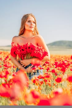 Woman poppies field. portrait of a happy woman with long hair in a poppy field and enjoying the beauty of nature in a warm summer day