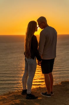 At sunset, a couple shares a tender embrace on the beach, basking in the tranquility of their holiday and the beauty of nature