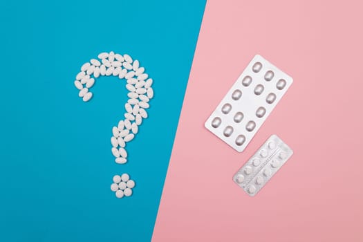 Question Mark Made from White Pills and Tablets with Pill Packages, Lying on Split Blue and Pink Background. Global Pharmaceutical Industry and Medicinal Products