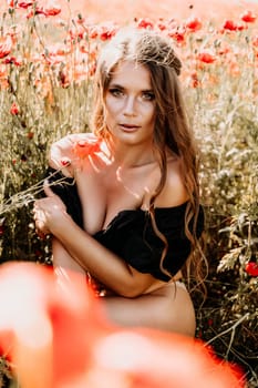 Woman poppies field. portrait of a happy woman with long hair in a poppy field and enjoying the beauty of nature in a warm summer day