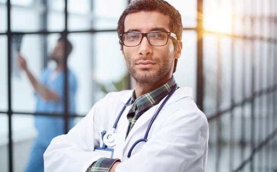 mature doctor posing and smiling at camera, healthcare and medicine.