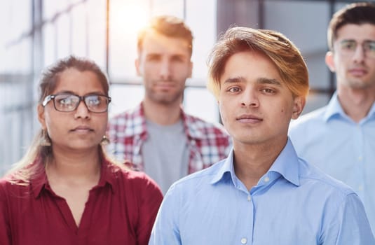 Were the ones who make things happen. Shot of a diverse group of businesspeople standing together in the office with their arms folded.