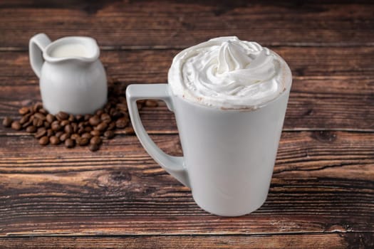 Cafe mocha in white porcelain cup on wooden table