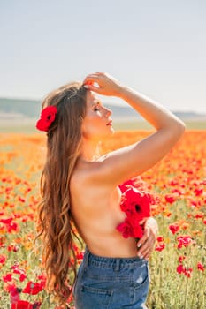 Woman poppies field. portrait of a happy woman with long hair in a poppy field and enjoying the beauty of nature in a warm summer day