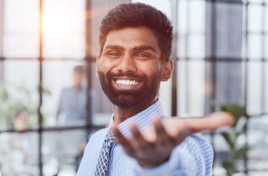 male investor beard looking at camera and smiling in modern office