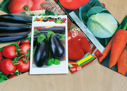 On the table are beautifully decorated packets of high quality seeds of various crops.