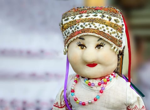 Crafts: original handmade doll in national headdress and dress, embellished necklace.