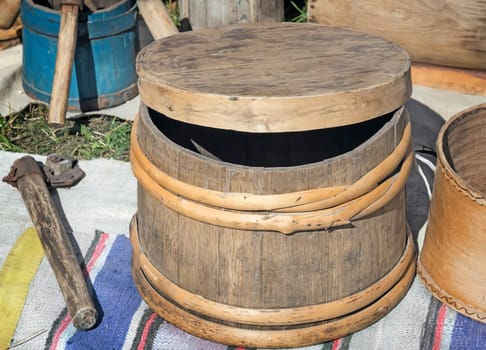 Old oak barrels with wooden hoops and objects of rural life.