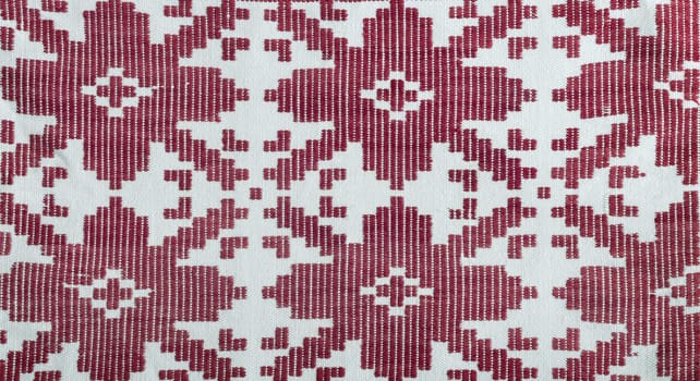 A fragment of ancient fabric with a beautiful pattern, made on a handmade loom.