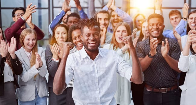 large international group of happy people applauding together standing in the lobby