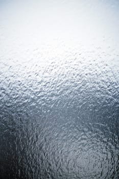 Freezing rain on a window, ice on the windowpane. Frost ice patterns on a window glass. Rime on a windowpane, Bitter cold. Frosted glass window. Ice Background.