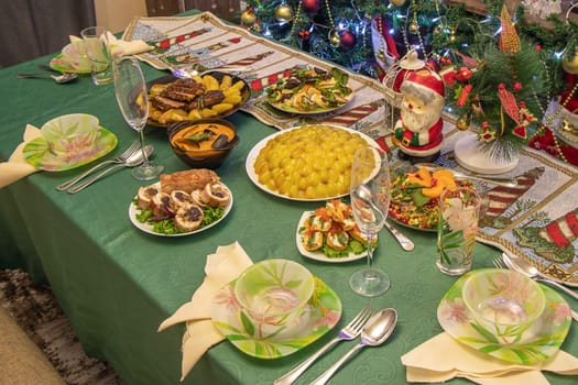 festive table against the background of Christmas decorations. Christmas and New Year celebration concept at home.