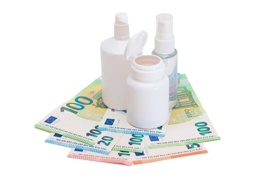 Different Bottles with Pills, Capsules and Medicines on the Euro Banknotes - Isolated on White. Global Pharmaceutical Industry and Big Pharma. Euro Money Bills - Isolation