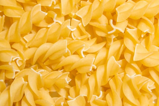 Uncooked Fusilli Pasta: A Culinary Canvas of Spiral Macaroni, Creating a Lively and Textured Background for Gourmet Cooking. Dry Pasta. Raw Macaroni - Top View, Flat Lay