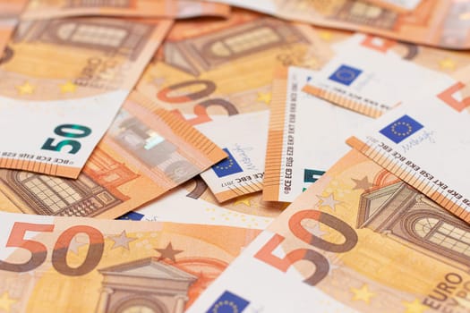 50 Euro Banknotes Money Background. Euro Money Currency. Orange Paper Money. A Lot of Fifty Euro Bills. Business, Finances, Cash and Money Saving Concept