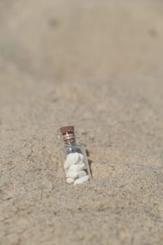 Souvenir Glass bottle with Sea shell. Seashell in glass bottle with seashells on the seashore sandy beach. Ocean seashell. Summer Memories from vacation Concept for travel agency