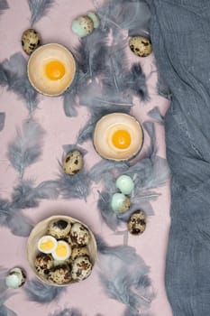 quail eggs in ceramic vases, gray feathers on the table, Easter still life with dietary eggs, diet and antioxidants, dark key and shallow depth of field, high quality photo