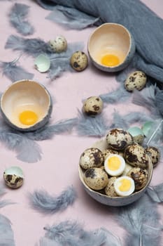 quail eggs in ceramic vases, gray feathers on the table, Easter still life with dietary eggs, diet and antioxidants, dark key and shallow depth of field, high quality photo