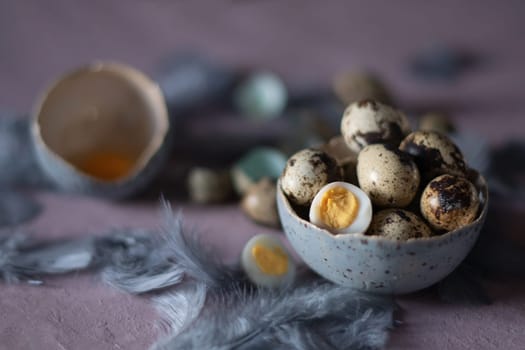 quail eggs in ceramic vases, gray feathers on the table, Easter still life with dietary eggs, diet and antioxidants, dark key and shallow depth of field, high quality photo