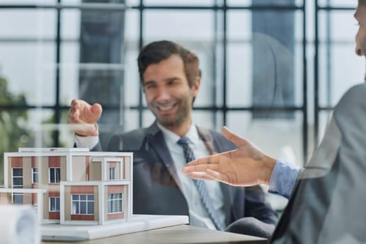 two successful people are discussing a house construction project