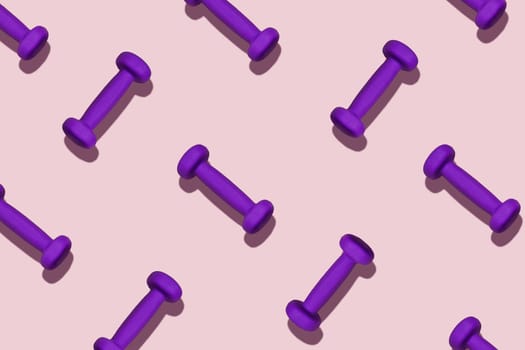 Group of purple dumbbells on a pink background.