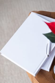 blank books for mockup design with pen and poinsettia plant