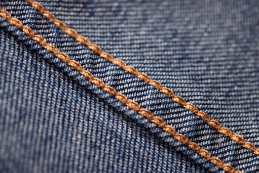 Seams on jeans close-up in high-resolution. Stitching on denim on the inside. Fabric texture. Blue jeans background and texture. Denim texture on the underside of the textile.